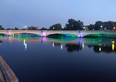 Colorful lights across the water next to a bridge